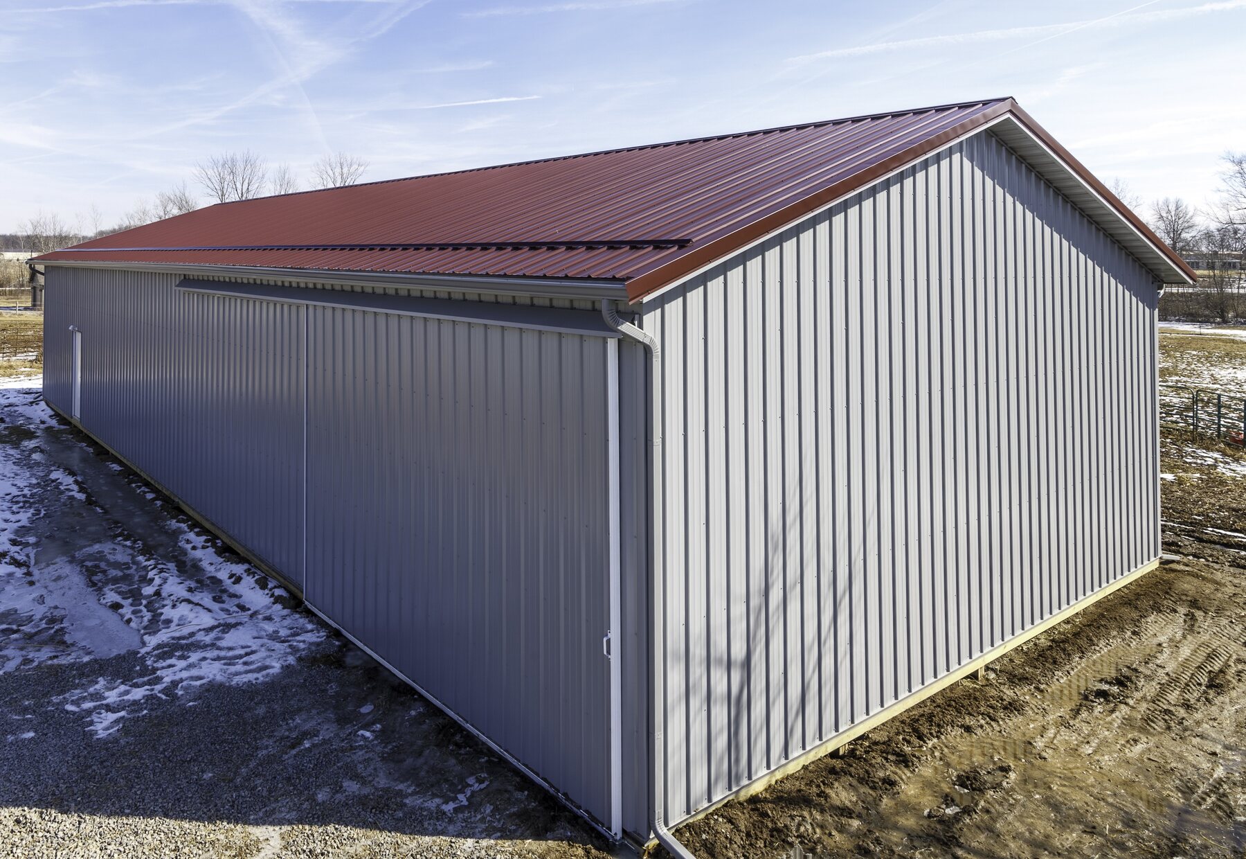 Burgundy rib-panel metal roof on a detached gray garage in Central Ohio
