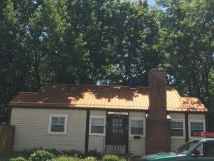 Copper-colored metal roof on a brick ranch home in Central Ohio