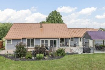 Copper-colored metal roof with a plum accent section on an Ohio home