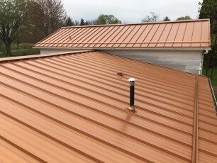 Close view of copper-colored standing-seam metal roof panels
